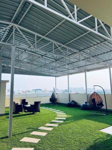 a large open structure with chairs and tables in a building at Stayhomestays Grande in Bengaluru