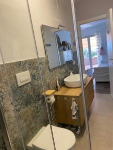 a bathroom with a sink and a toilet and a mirror at Villa Rosa Managed by Calabria Mare Experience in Diamante +19 photos