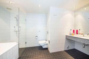 a bathroom with a toilet and a sink and a shower at Scandic Stavanger Airport in Sola