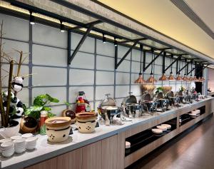 a kitchen with a counter with pots and pans at Citadines Guanghua Chengdu in Chengdu