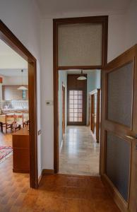 an empty hallway with a door and a living room at Casa Giuly in Lezzeno