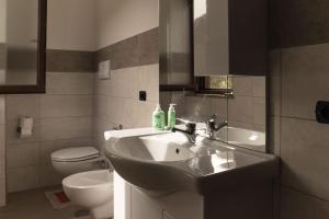 a bathroom with a sink and a toilet at Villetta Luneria in Pisciotta