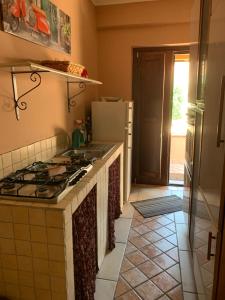 a kitchen with a stove and a counter top at Villa Anna! in Castrocielo +52 photos