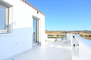 a white house with a view at Evridiki apartments in Kithnos