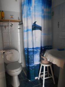a bathroom with a toilet and a shower curtain at Meltemia Studio Samos near the beach in Kámpos +23 photos