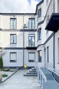 a white building with windows and a stairway at Studio LOFT12 in Kielce +10 photos