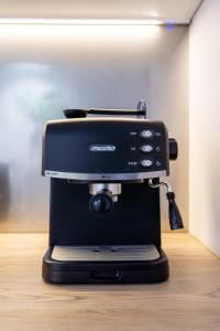 a black coffee maker sitting on top of a table at Studio LOFT12 in Kielce