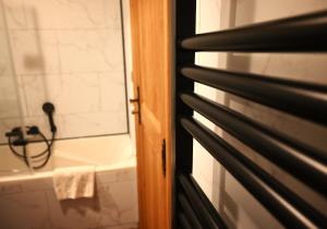 a bathroom with a tub and a sink and a window at Hotel Au Coeur de Lacuisine in Florenville +84 photos