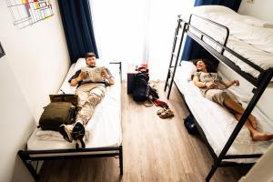 Postel nebo postele na pokoji v ubytování Bud Gett Hostels