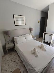 Postel nebo postele na pokoji v ubytování Karis Hotel