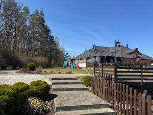 a set of stairs leading up to a playground at Restauracja&Hotel w Dolinie Pstrąga in Machowa