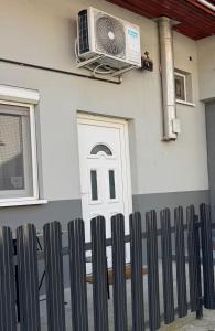 a house with a white door and a fan at Cozy Modern Studio in Debrecen