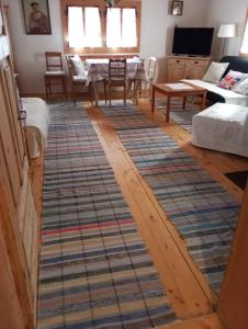 a living room with a rug on the floor at Drevenica Traditional Cottage Old Centre in Zuberec
