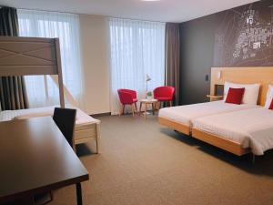 Postel nebo postele na pokoji v ubytování SwissTech Hotel