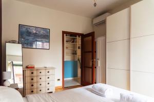 a bedroom with a bed and a dresser and a mirror at Youhosty - Val Passiria 4 in Milan