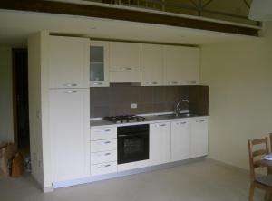 a kitchen with white cabinets and a sink and a stove at Casa con panorama in Monticello