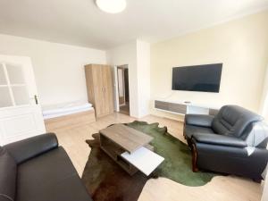 a living room with two couches and a tv at Penzión na Sihoti in Trenčín +16 photos
