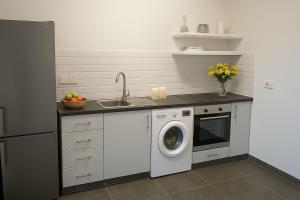 a kitchen with a washing machine and a sink at Studio by The Sea in Limassol