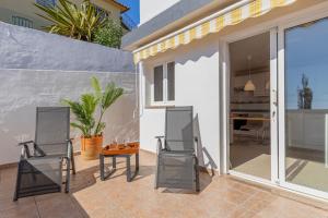a patio with two chairs and a table at Casa Málaga by Huskalia in Tazacorte +16 photos