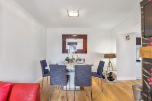 a dining room with a table and chairs at Stewards Cottage - North East Escapes in Bamburgh +23 photos