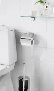 a white bathroom with a toilet and a shelf at habitacion 1 in Zaragoza