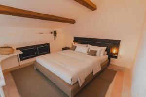 a bedroom with a large bed in a room at [Duomo - City Center] Appartamento elegante con suite in Ravenna