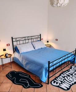 a bedroom with a bed with a blue comforter at Appartamento Brufani in Santa Maria degli Angeli +33 photos