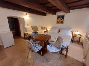 a bedroom with a bed and a table and chairs at Pension Nina in Český Krumlov