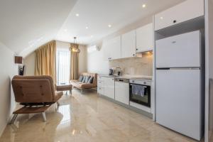 a kitchen with a couch and a chair in a room at Jasmin 8 2+1 NEW! in Alanya