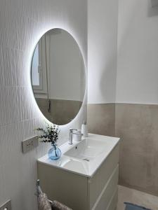 a bathroom with a white sink and a mirror at Glamour in Alassio