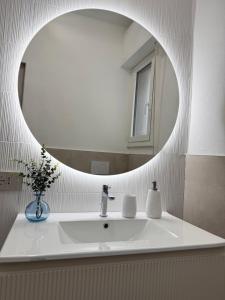 a bathroom with a white sink and a mirror at Glamour in Alassio
