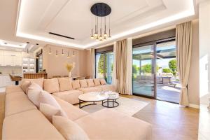 a living room with a large couch and a table at Villa Arthur in Kassiopi