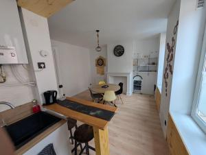 a kitchen and dining room with a table in a room at Appartement 50m² centre-ville in Dunkerque +8 photos