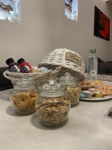a table with jars of food and a plate of cookies at La casetta di Giogi in Sutri