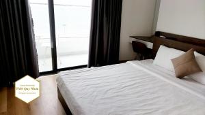 Giường trong phòng chung tại TMS Quy Nhơn Luxury Homestay