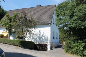 une maison blanche avec un toit marron dans l'établissement Ferienwohnung Weber, à Schleiden