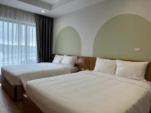 Giường trong phòng chung tại TMS Quy Nhơn Luxury Homestay