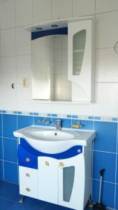 a blue and white bathroom with a sink at Hostelhome in Türkistan +37 photos