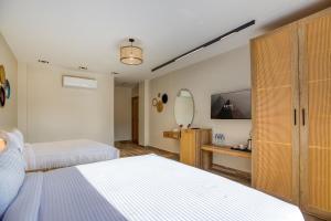 A bed or beds in a room at Beyond Pyramids View