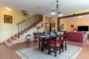 a living room with a table and a staircase at GuestHost - Eden Green Oasis in Giardini Naxos