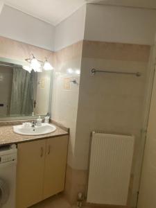 a bathroom with a sink and a mirror at Central location! Spacious 2 bdrm with balcony in Sparta +14 photos