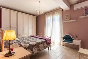 a bedroom with a bed and a window at GuestHost - Eden Green Oasis in Giardini Naxos