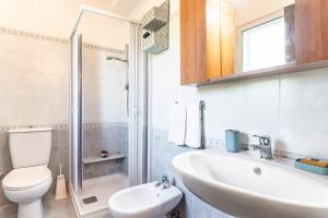 a bathroom with a toilet and a sink and a shower at GuestHost - Eden Green Oasis in Giardini Naxos +20 photos