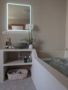 a bathroom with a sink and a mirror at Gaiamoment La casa la panadera in Alcalá del Júcar +9 photos