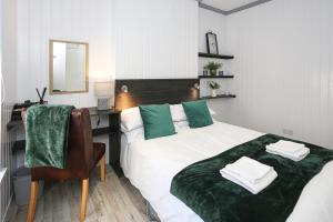 a bedroom with a bed with a desk and a chair at Queens Quarter in Belfast