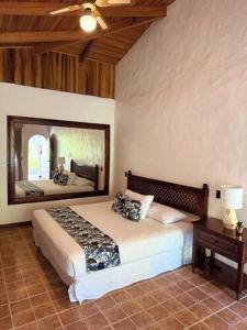 a bedroom with a bed and a large mirror at Rancho Rio Perlas in Cartago +103 photos