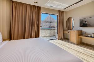 A bed or beds in a room at Beyond Pyramids View