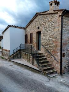 a brick building with stairs on the side of it at Appartamento turistico Carboni 2 in Penna San Giovanni