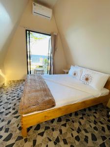 a bed in a room with a large window at Seabreeze Haven Resort in Maria +53 photos