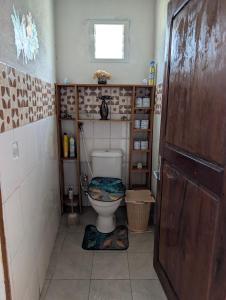 a small bathroom with a toilet in a room at Le tournesol Belle villa in Maroantsetra +17 photos